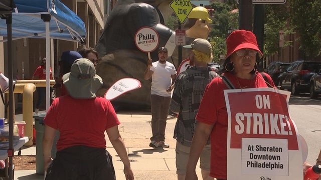 Workers carry signs during a strike at the Sheraton Downtown hotel in Philadelphia 