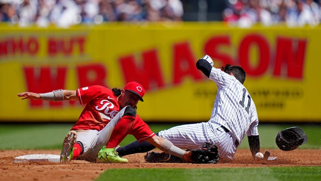 Anthony Volpe #11 of the New York Yankees slides into second as Edwin Arroyo #2 of the Cincinnati Reds fields the throw during the game at Yankee Stadium on Saturday, June 20, 2026 in New York, New York. 