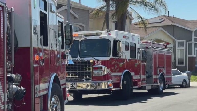 fire trucks parked outside of a home 