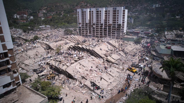 Residents and rescue workers search through the rubble two days after an earthquake struck La Guaira, Venezuela, Friday, June 26, 2026. 