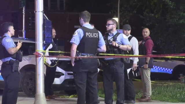 Flashing Lights and Police Tape Reading "Police Line Do Not Cross" 