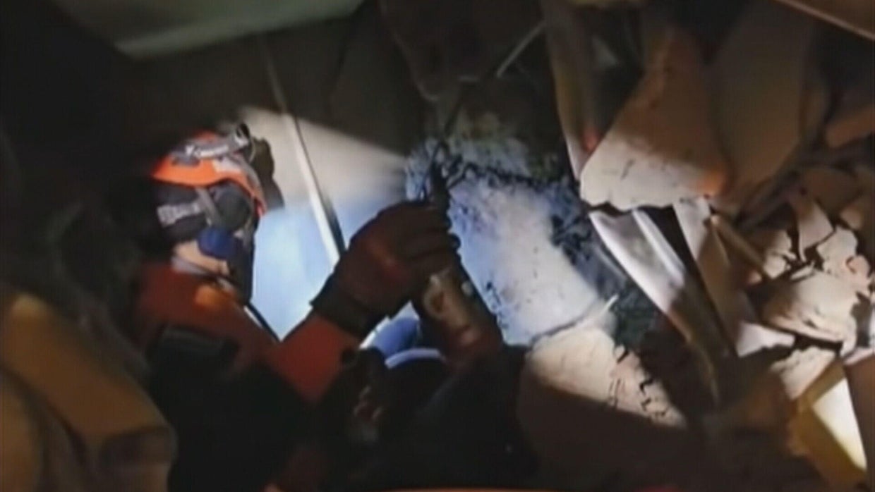 Rescue teams in Venezuela race to save security guard trapped under ...