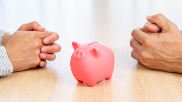 A man and a woman discussing money. 