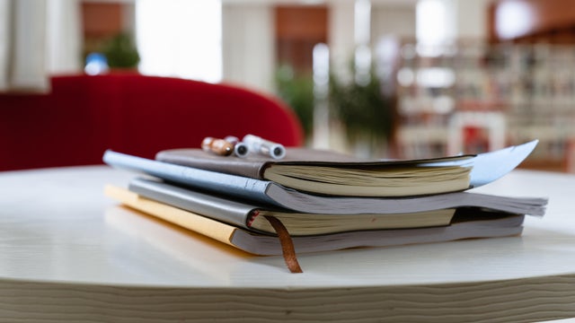 A stack of books on a table in the library 