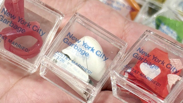 Trash in small cubes labeled "New York City Garbage. JUST&T MARRIED! 7/3/26" 