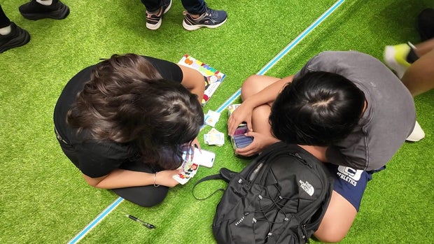 People trading stickers