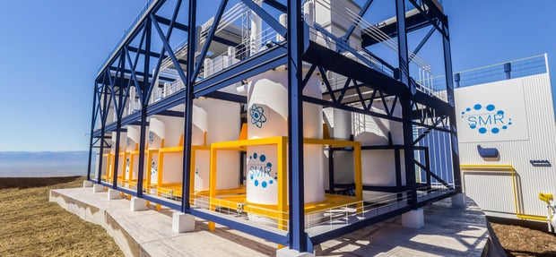 concept of a SMR small modular nuclear reactor power plant on a sunny day. SMR is a future energy concept. 3d rendering. 
