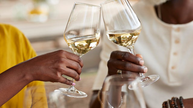 Couple toasting wineglasses at winery 