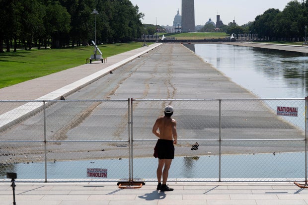 A person stops to look at the partially-drained Lincoln Memorial Reflecting Pool, Monday, July 13, 2026, in Washington.