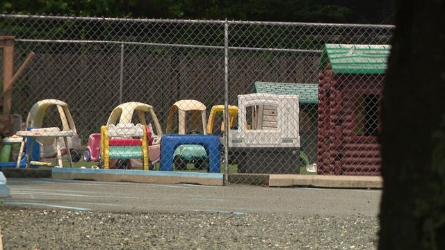 Children's toys in yard behind fence 