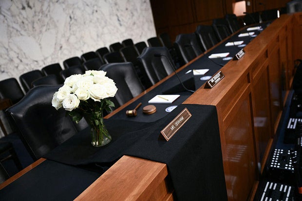 A black drape and flowers are placed at the seat of late Sen. Lindsey Graham at the Senate Judiciary Committee on July 15, 2026. 