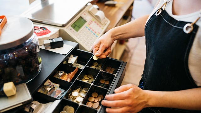 Woman using a cash till 