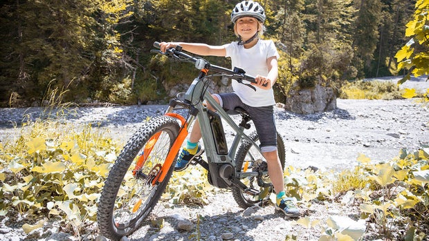 Boy in the mountains with his e-mountain bike