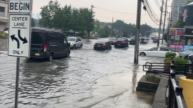 Cars driving through flooded streets