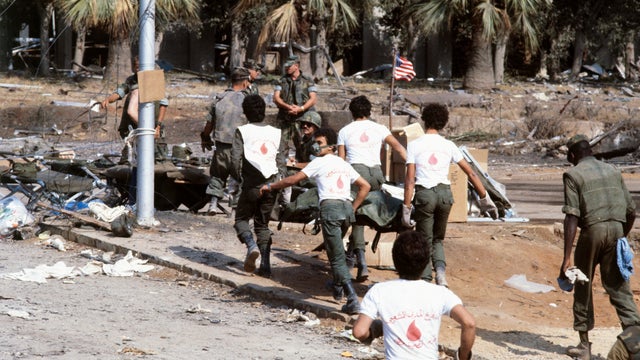 Lebanese volunteer rescue workers carry the body of an 