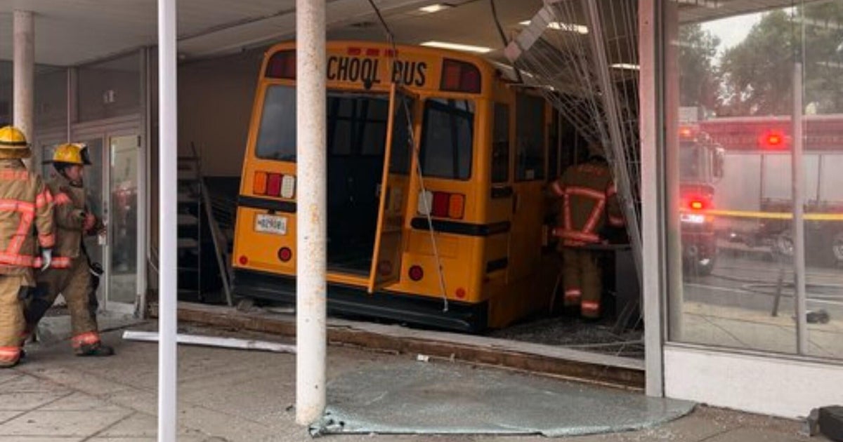 Car veered in front of school bus that crashed into Parkville building, police say