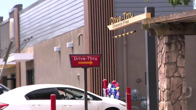A car enters a fast food drive-thru 