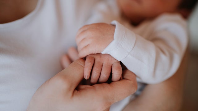 mother holding a newborn baby 