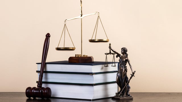 The figure of Themis, the judge's gavel, books and scales of justice 