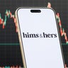 Hims & Hers Logo Shown on Smartphone with Latest Stock Market Chart 