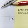 "Debt Collection" written on a sticky note on a calendar, representing deadlines, financial pressure, and credit management. 