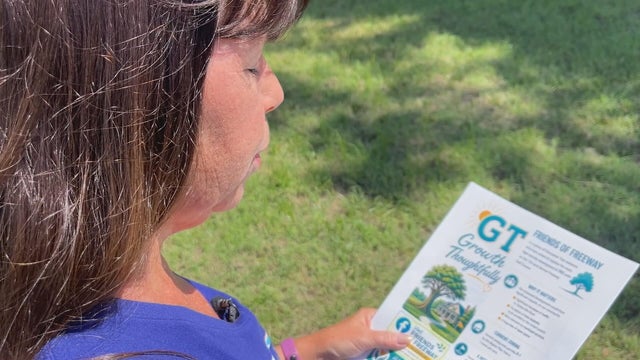 Nancy Gentile looks at a flyer about the proposed housing development 