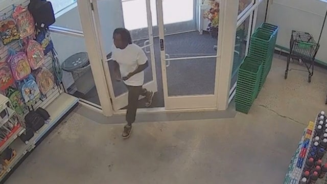 A man walks into a Dollar Store in this surveillance video from inside the shop 