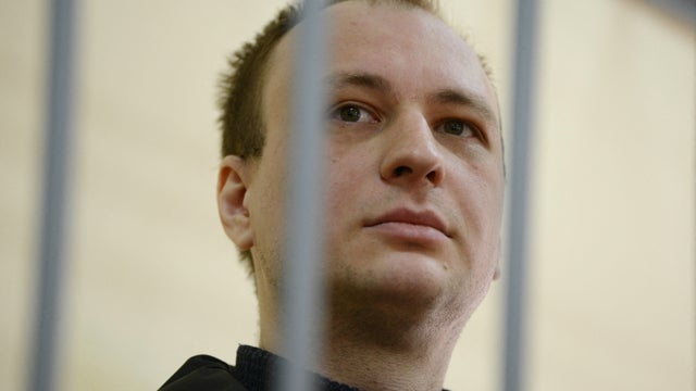 Robert Gilman behind bars at a court hearing in Russia 