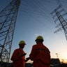 Workers checking high-voltage power lines. 