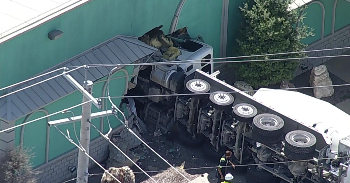 Concrete truck overturns, crashes into Dallas business, authorities say
