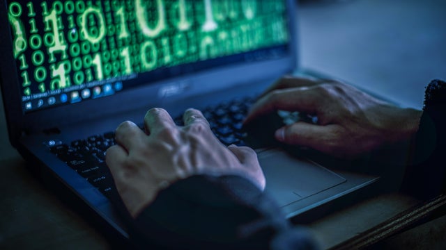 Hacker stealing password and identity, computer crime. 