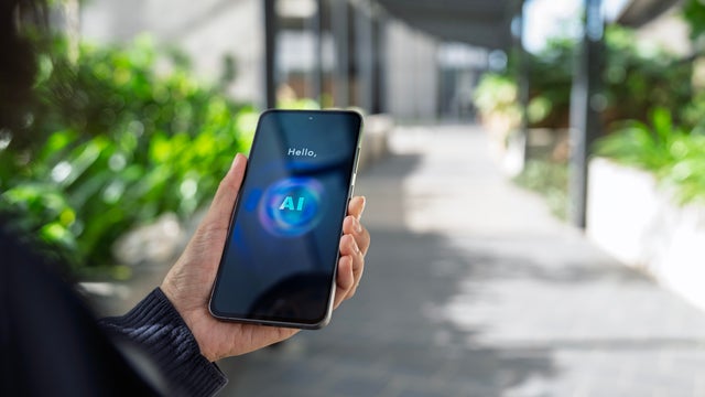 Person using AI assistant on smartphone outdoors 