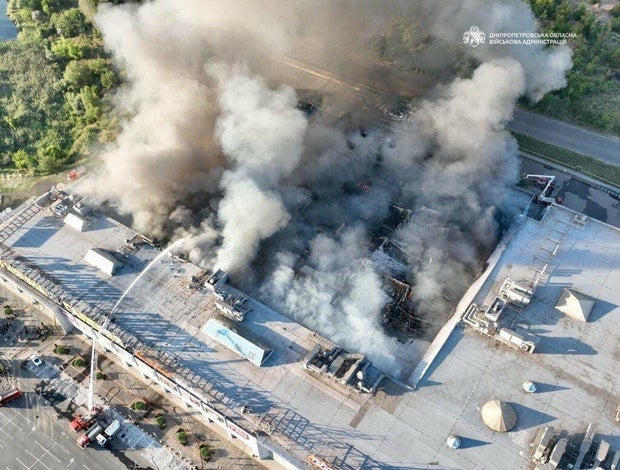 Firefighters work at the site of a shopping mall hit by Russian drone strikes in Kryvyi Rih, Ukraine, Aug. 21, 2026. 