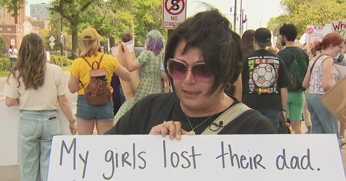 Protesters gather at Blue Cross Blue Shield of Michigan headquarters after policy changes