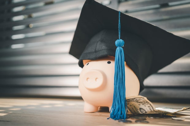 Black graduation hat and piggy bank concept investment in education Graduation save money for education 