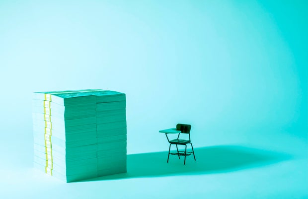 The cost of Education - Money and desk 
