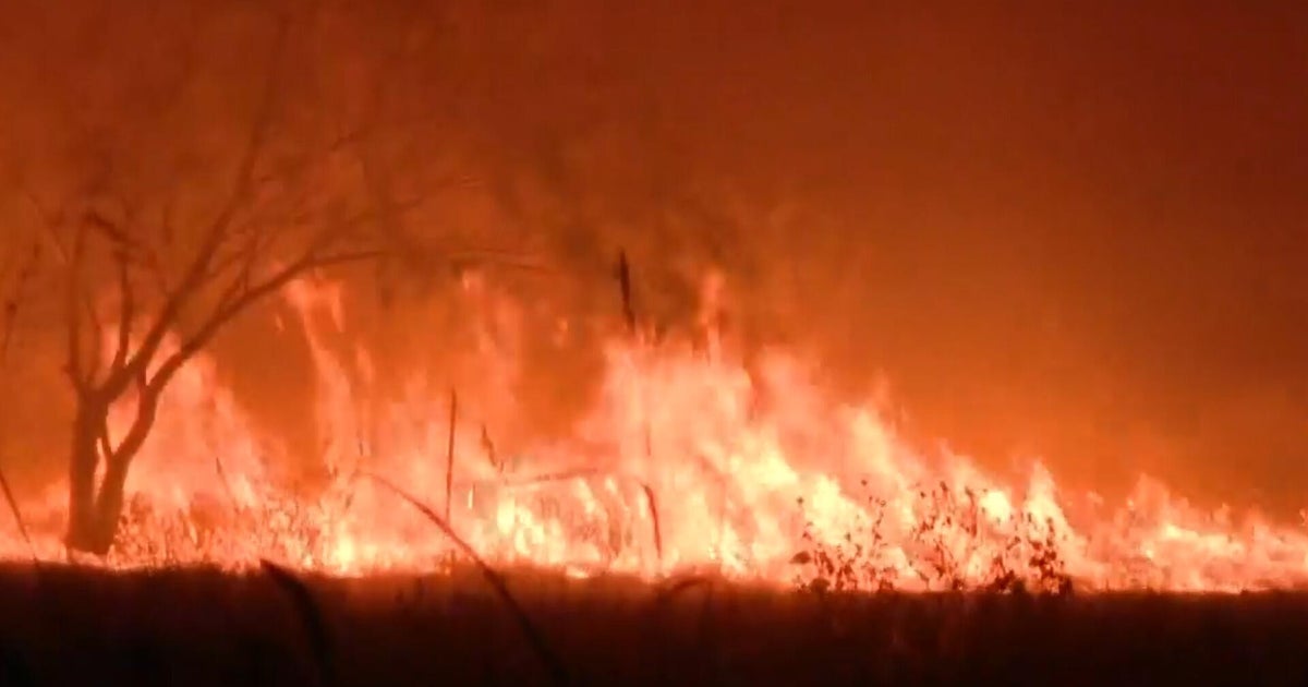 Heat-fueled wildfires tear through U.S., consuming thousands of acres