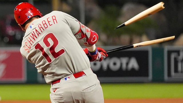 Kyle Schwarber's bat breaks as he hits a foul ball during a game against the Los Angeles Angels 