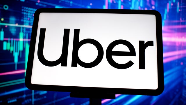 In this photo illustration, the Uber logo is seen displayed 