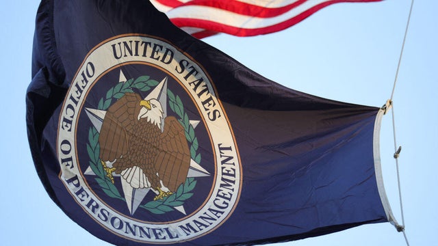 An organizational flag flies outside of the Office of Personnel Management in Washington, D.C., on Feb. 7, 2025. 