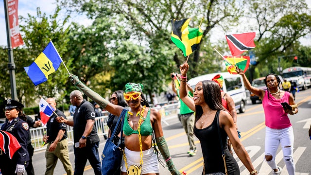 Participants wear and wave flags during the 2025 NYC West Indian Day Parade in Brooklyn on September 01, 2025 in New York City. 