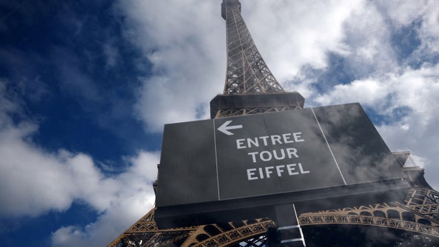 A sign directs visitors to the entrance for the Eiffel Tower in Paris, Sept. 7, 2026. 