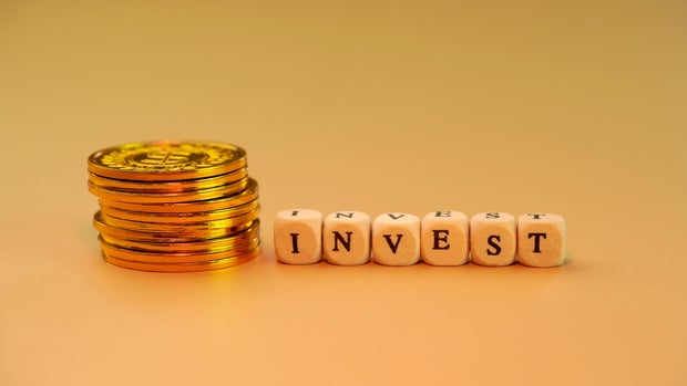 invest word with gold coins stack invest word with gold coins stack