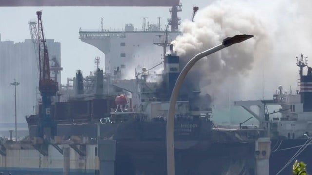 Smoke billows out from a cargo ship that caught fire while docked at a port in the city Qingdao in eastern China's Shandong province, in a photo from video taken Sept. 10, 2026, and released by Qingdaowolin. 