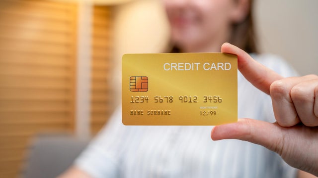 Woman making online purchase with tablet and credit card. 
