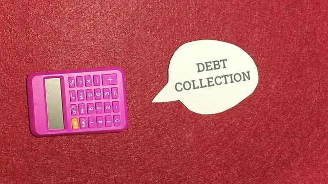 Bright pink calculator sitting next to a white speech bubble with debt collection text written inside 