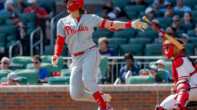 Alec Bohm tosses his bat after hitting a two-run double against the Braves in Atlanta 