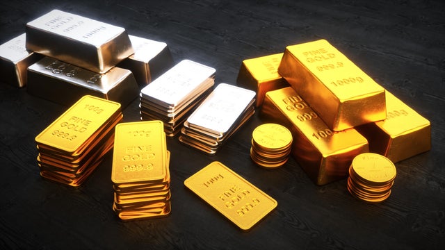 Stacks of precious metal ingots and coins 