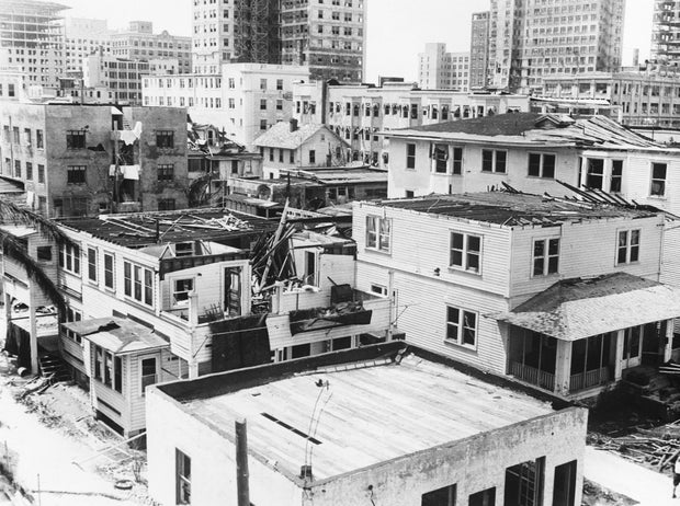 Houses W/Broken Windows & Damaged Roofs
