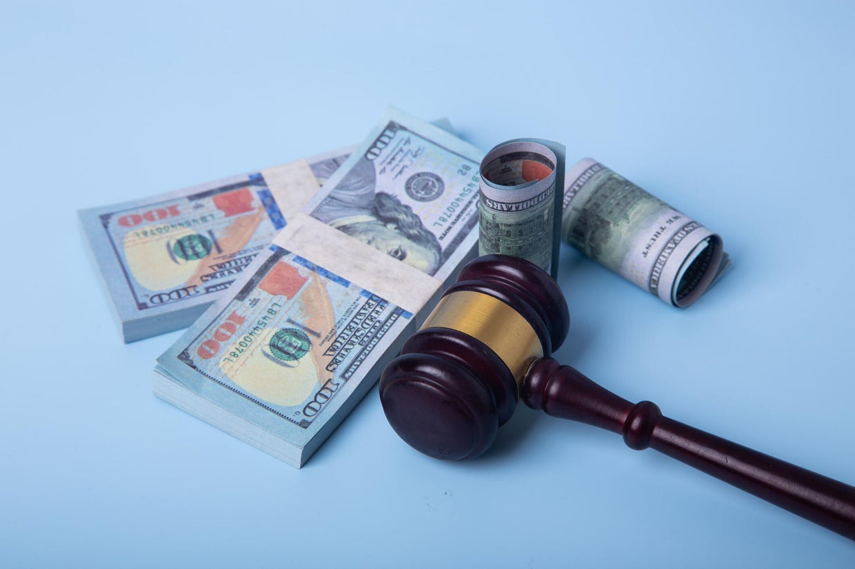 Gavel and money representing legal financial settlement